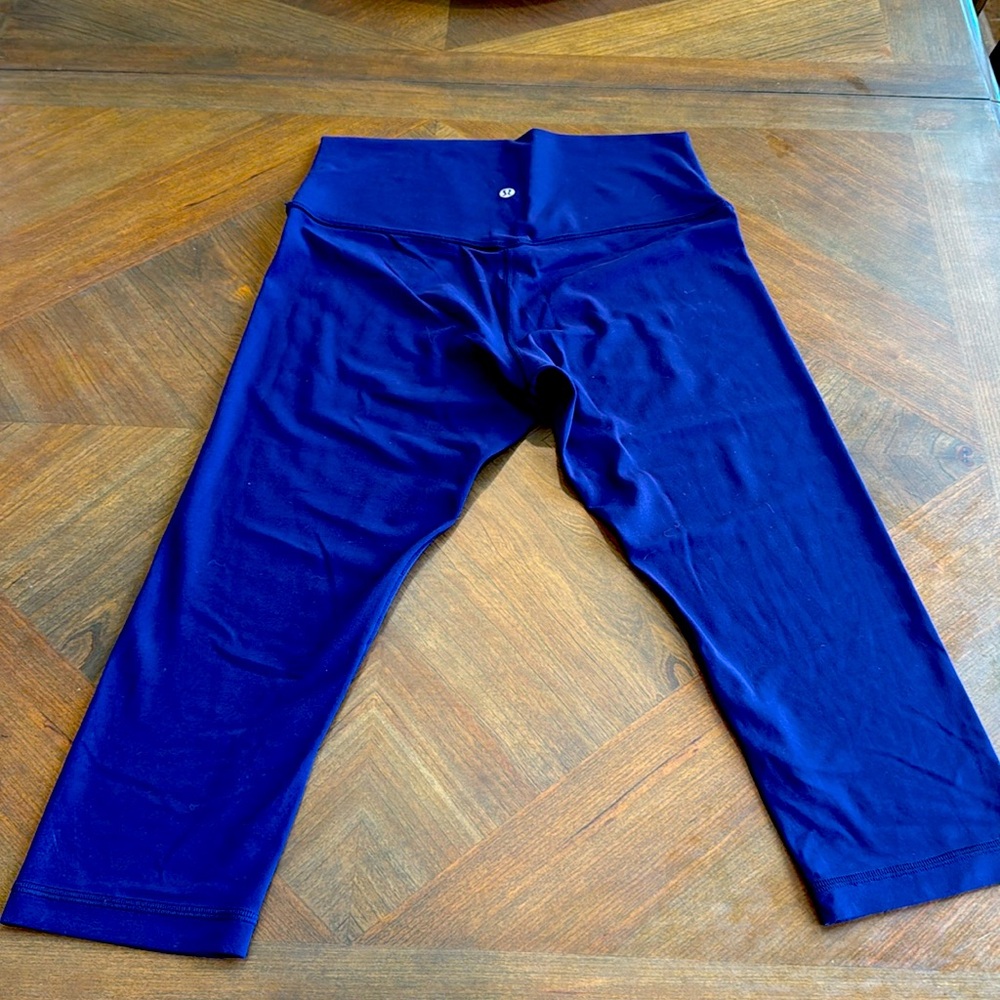 - Ladies Lululemon deep purple cropped leggings.